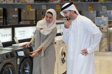 Emirati Couple Shopping for Washing Machine in Store