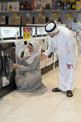 Emirati Couple Shopping for Washing Machine in Store