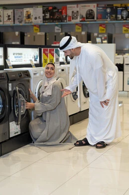 زوجان إماراتيان يتسوقان لشراء غسالة ملابس من متجر