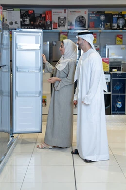 Emirati Couple Shopping for Refrigerator in Appliance Store