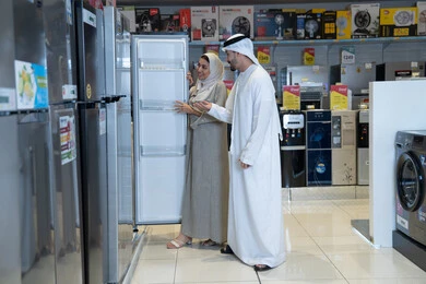 Emirati Couple Shopping for Refrigerator in Appliance Store