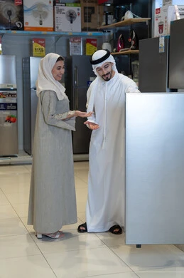 زوج إماراتي يتسوق لشراء أجهزة منزلية في صالة عرض
