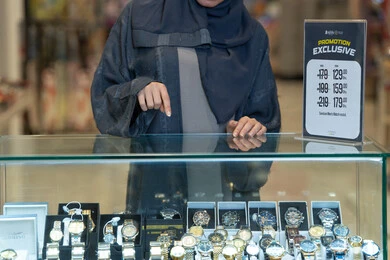 Emirati Woman Shopping for Luxury Watches in Store