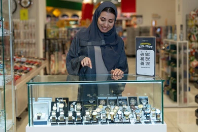 Saudi Woman Shopping for Luxury Watches in Retail Store