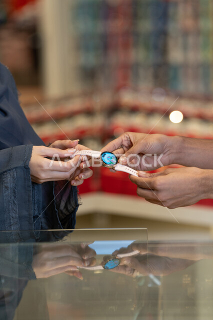 Saudi Woman Shopping for Smartwatch in Electronics Store