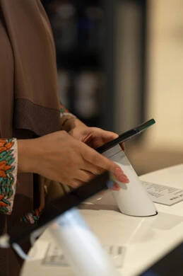 Arab Woman Using Digital Tablet in Showroom