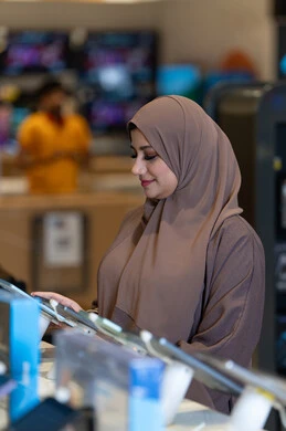 Arab Woman in Hijab Shopping for Tablets in Store