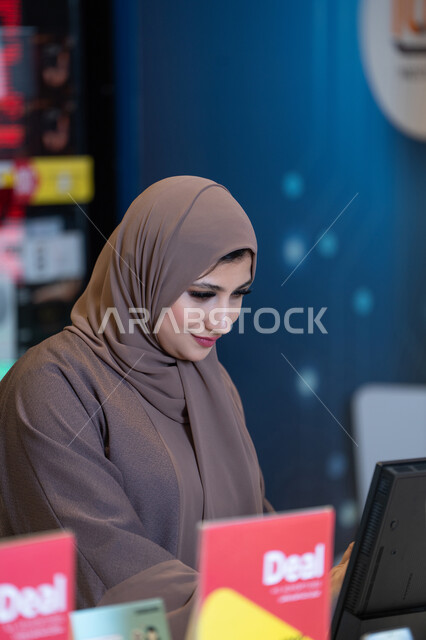 Emirati Woman in Hijab Working at Retail Counter