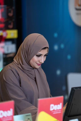 Emirati Woman in Hijab Working at Retail Counter