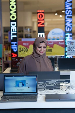 Arab Woman Shopping for Laptop in Electronics Store Arab Woman Shopping for Laptop in Electronics Store