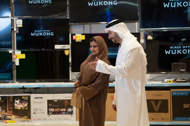 Emirati Couple Shopping for Televisions in Electronics Store