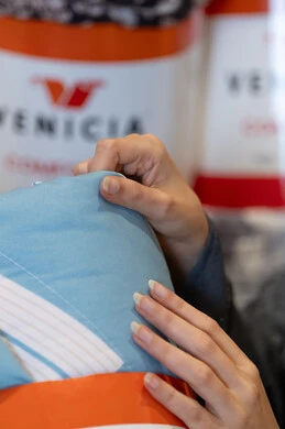 Close-up of Hand Touching Blue Fabric in Retail Shop