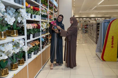 Arab Women Shopping for Artificial Flowers in Home Store