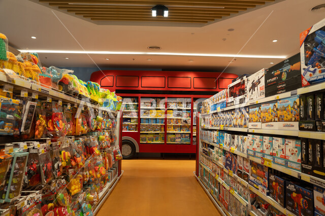 منظر داخلي لممر متجر ألعاب مع رف حافلة حمراء