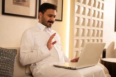 Arab Man in Saudi Thobe on Laptop Video Call