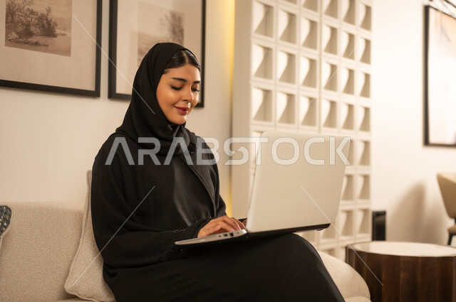 امرأة سعودية تستخدم الكمبيوتر المحمول في مكتب منزلي