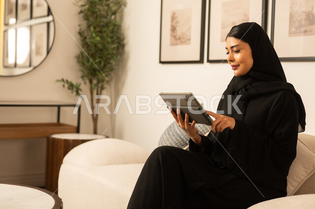 Saudi Woman Using Digital Tablet in Modern Home