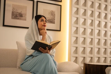 Saudi Woman Reading Book in Modern Living Room