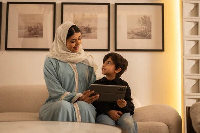 Arab Woman and Child Using Tablet Computer at Home