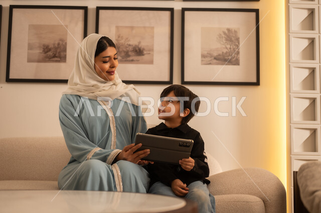 Arab Woman and Boy with Tablet in Modern Living Room
