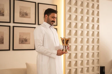 Saudi Man Holding Traditional Incense Burner in Modern Home Saudi Man Holding Traditional Incense Burner in Modern Home