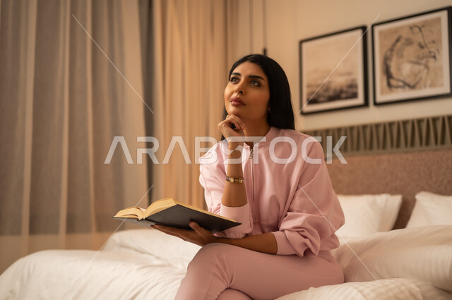 Saudi Woman Reading Book in Bedroom at Night