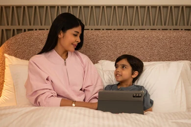 Arab Mother and Son with Tablet in Bedroom