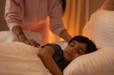 Child Sleeping in Bedroom with Mother Watching Over Him