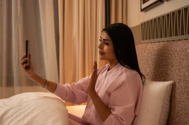 Woman in Bedroom Making Video Call on Smartphone