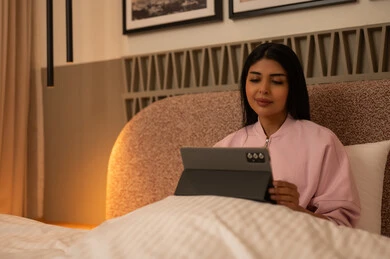 Arab Woman Using Tablet in Modern Bed