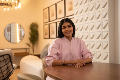 Middle Eastern Woman in Pink Jacket in Modern Interior
