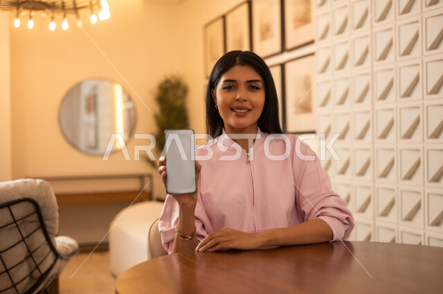 Saudi Woman Holding Smartphone with Blank Screen Mockup