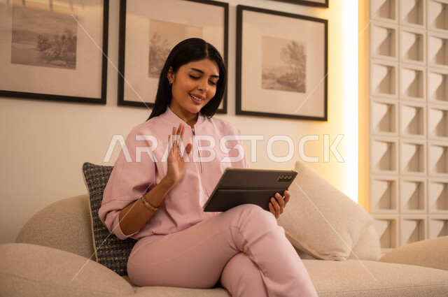 امرأة عربية تلوح أثناء مكالمة فيديو على الجهاز اللوحي