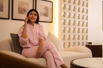 Arab Woman Talking on Smartphone in Modern Living Room