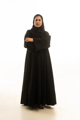 امرأة سعودية بالعباءة السوداء على خلفية بيضاء