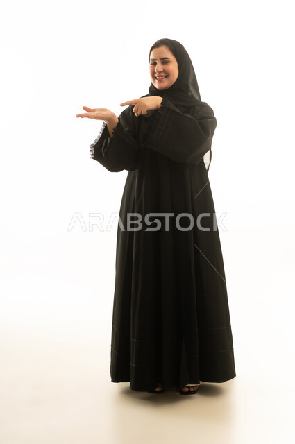 Saudi Woman in Black Abaya Pointing to Palm