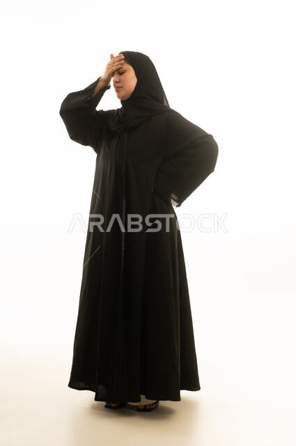 Saudi Woman in Black Abaya Suffering from Headache