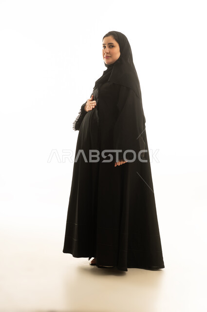 Pregnant Saudi Woman in Black Abaya on White Background