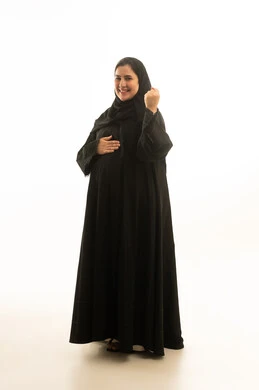 امرأة سعودية حامل بالعباءة السوداء على خلفية بيضاء امرأة سعودية حامل بالعباءة السوداء على خلفية بيضاء