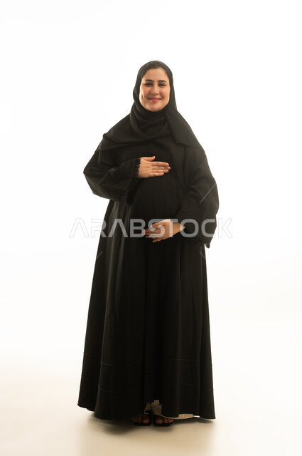 Pregnant Saudi Woman in Black Abaya on White Background