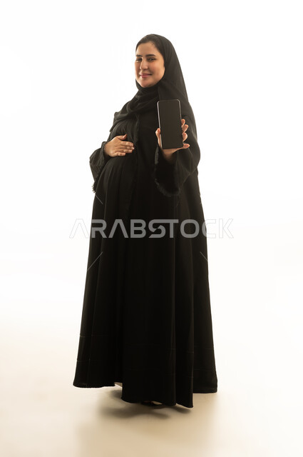 Pregnant Saudi Woman Holding Smartphone on White Background