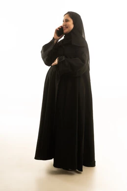 Saudi Woman in Black Abaya Using Smartphone