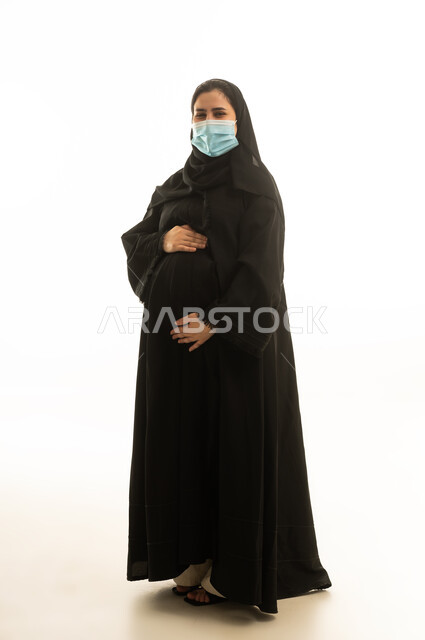 Pregnant Saudi Woman in Abaya Wearing Face Mask
