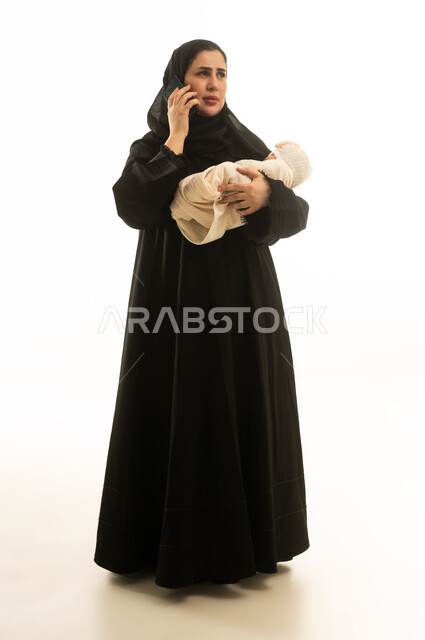 Saudi Mother with Baby Talking on Phone