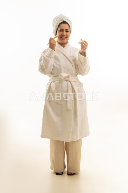 Saudi Woman in White Bathrobe Applying Skincare