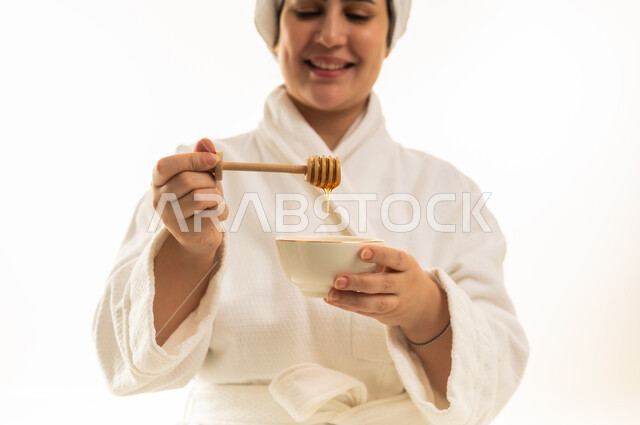 Arab Woman in Bathrobe Using Honey for Skincare