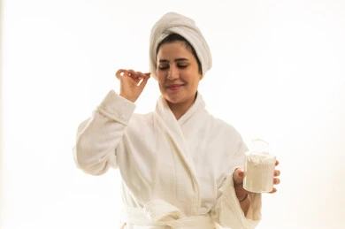 Arab Woman in Bathrobe with Skincare Cream
