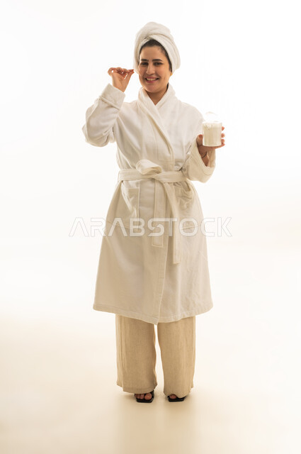 Arab Woman in White Bathrobe with Cotton Swabs