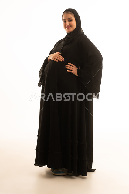 Pregnant Saudi Woman in Black Abaya on White Background