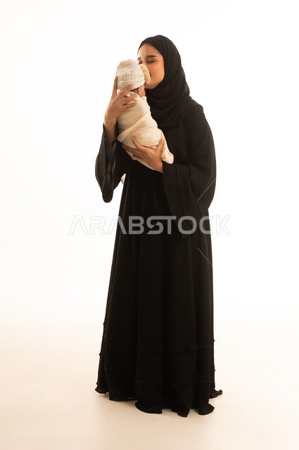 Saudi Woman Holding Newborn Baby in White Studio